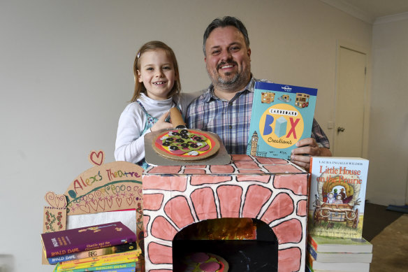 Wayne Murphy and his seven-year-old daughter Alexandra with the cardboard pizza oven they've made following instructions in a children's craft book. 