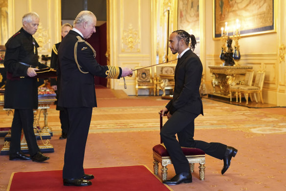 Prince Charles knights Sir Lewis Hamilton at Windsor Castle.