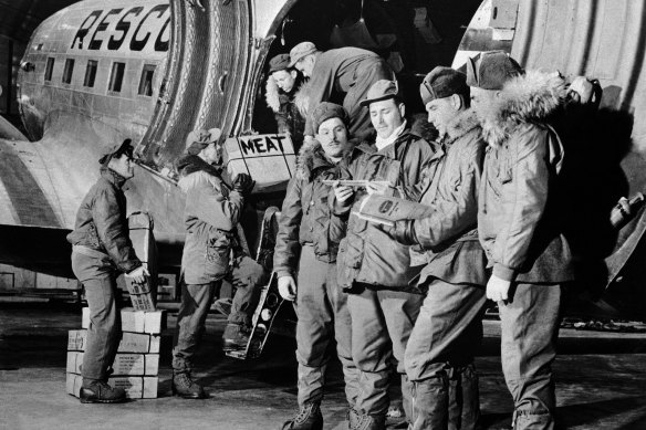 US military men unload food supplies in Thule c 1965.