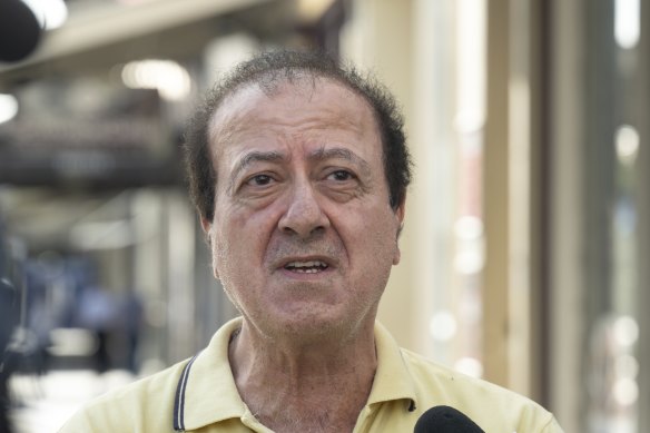 Leo Raffoul speaks outside the burnt-out shop on Nelson Place, Williamstown on Friday.