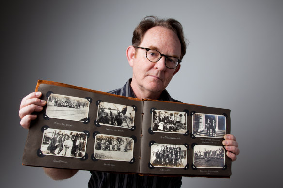 Lindsay Barrett with his photo album in the Powerhouse Museum photographic studio.  