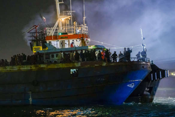 A fishing boat with some 500 migrants enters the southern Italian port of Crotone last month. 