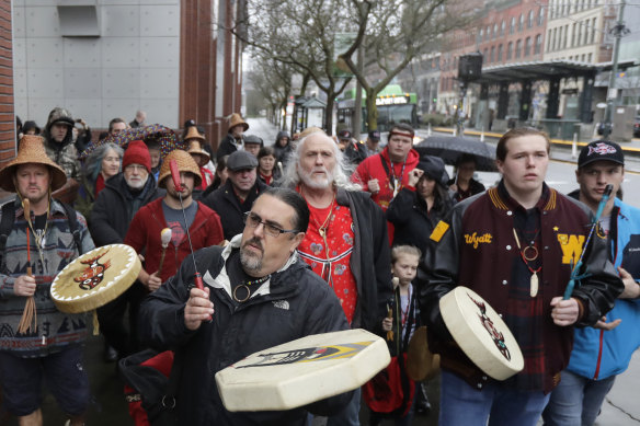 Naschio Johnson, centre, chairman of the Chinook Indian Nation, plays a drum as he leads a march to the federal courthouse in Tacoma, Washington, latt year, an effort to regain federal recognition.