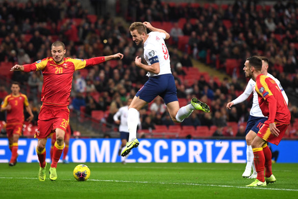 Harry Kane (centre) had a first-half hat-trick against Montenegro in England's 1000th match.