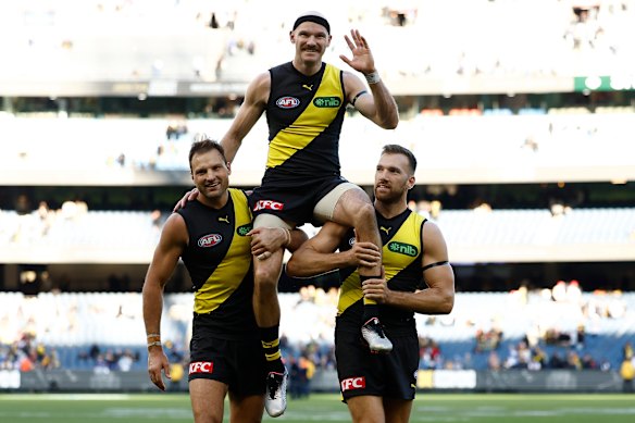 The Tigers show their respect for Kamdyn McIntosh after Sunday’s narrow loss to North Melbourne.
