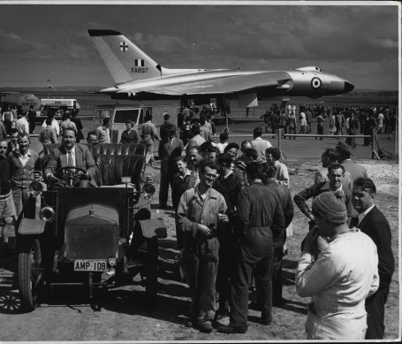 The Vulcan aircraft is greeted by its namesake - a 1908 Vulcan car - at Mascot. The car, the only one of its kind still running in Australia, was owned and driven by the president of the Veteran Car Club, John McClean. September 18, 1956.
