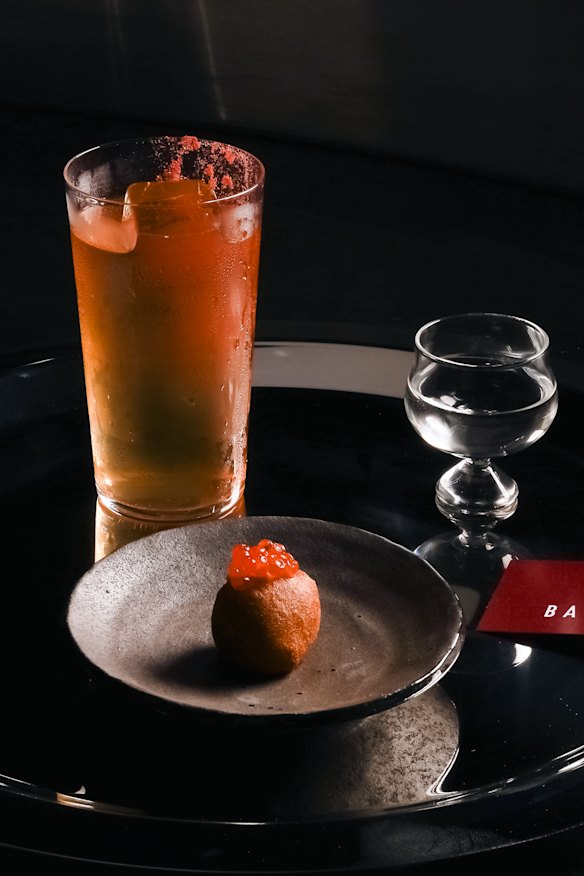 Sake cocktail with an ikura (salmon roe) doughnut.