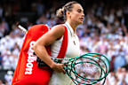 Aryna Sabalenka walks off after losing at Wimbledon.