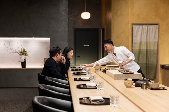 Chef Tomotaka Ishizuka behind the counter of his Kaga kaiseki restaurant.