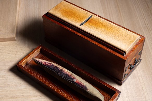 An antique bonito grater, with the dried bonito on the side.
