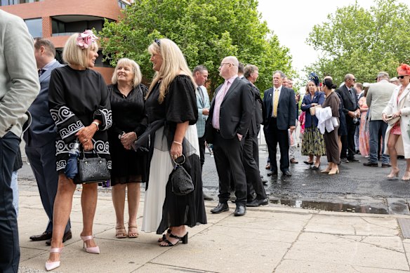 Friends Lisa McMahon, Jenny Matthews and Leanne Gomm queueing at the 2025 Caulfield Cup.