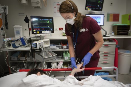 An emergency physician treats a patient at the Royal Melbourne Hospital.