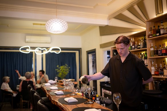 The marble chefs’ table (rear) and bar.