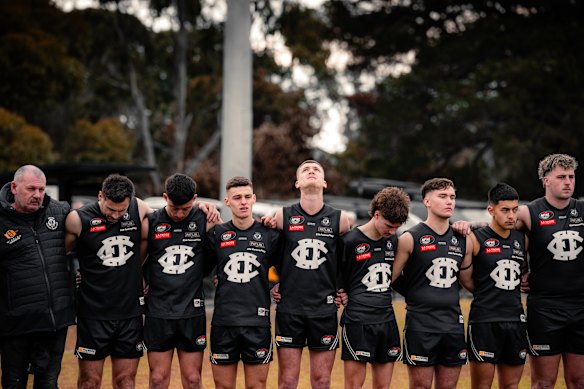 Epping footballers join in a moment of silence for Nathan Fitzgerald, who died from head injuries sustained during a game.