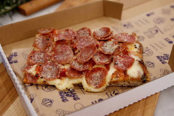 Salami pizza slice.