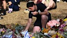 A man lays flowers outside the Bondi Pavilion on Wednesday.