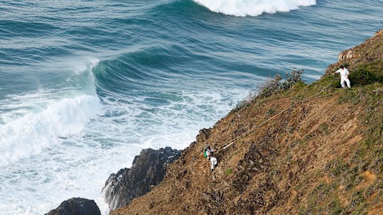 Police abseilers conduct the final physical search for Theo Hayez before efforts were suspended.