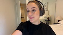 Lisa wearing the Beats Studio Pro in deep brown. 