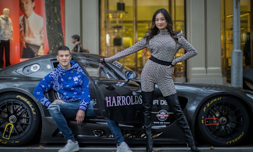 Harrolds luxury department store managing director Ross Poulakis (wearing Amiri) and womenswear manager Jessica Poon (wearing Balmain and Amina Muaddi boots) pose with their liveried Mercedes at their flagship store in Collins St, Melbourne.