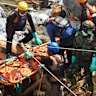 Rescuers evacuate the body of a flood victim in West Sumatra.