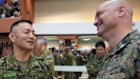 Japan army Major General Toshikatsu Musha, left, talks with a US marines after the opening ceremonies of joint military exercises in Quezon City, Philippines.