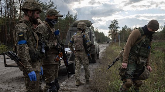 Ukrainian servicemen find a dead body while they search for comrades killed in fighting in the recently recaptured town of Lyman, Ukraine.