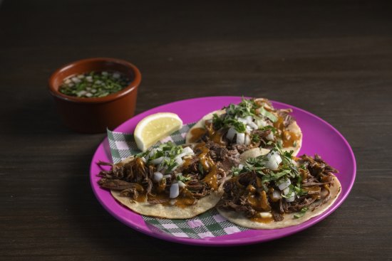 El Columpio’s lamb barbacoa tacos with chilli consomme.
