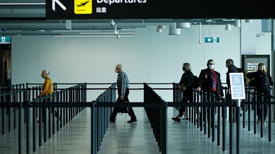 People check-in for flights at Melbourne Airport.