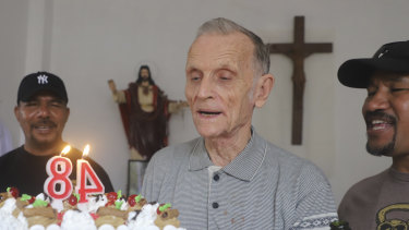 Now-defrocked Catholic priest Richard Daschbach, centre, is presented a cake during his 84th birthday in Dili in January. Former East Timor president Xanana Gusmao was photographed feeding Daschbach cake that day.