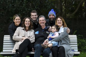Neale Daniher has received a Queens Birthday Honour for his work with FightMND. Daughter Bec Daniher is on his left, wife Jan Daniher is on his right holding granddaughter Rosie McKenna. Back from left are Maddi Gale, Ben Daniher and Michael McKenna. 