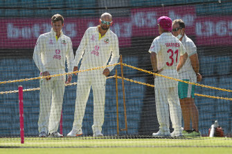 Nathan Lyon, Steve Smith and David Warner chat to Justin Langer as they inspect the pitch during an Australian nets session at the Sydney Cricket Ground.
