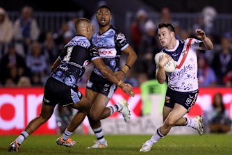 Rooosters halfback Luke Keary tries to slip past Cronulla fullback Will Kennedy.