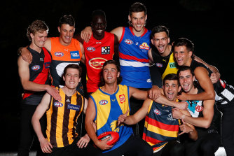 First-round draftees, including Mac Andrew (third from left, top row), pose for a photo on Wednesday night.