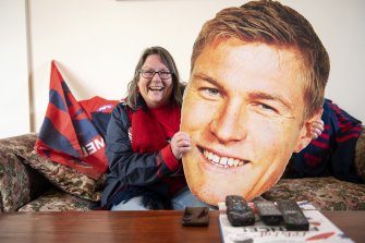 Demons cheer squad member Suzanne Considine celebrates her teamâs win while watching at home.
