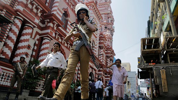 A Sri Lankan police officer patrols outside a mosque in Colombo on Wednesday.
