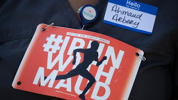 A woman displays a sign during a rally to protest the shooting of Ahmaud Arbery, an unarmed black man in Brunswick, Georgia. 