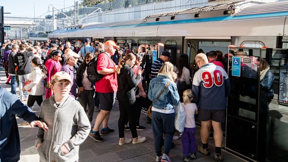 Passengers board the metro train at Tallawong Station on Sunday.
