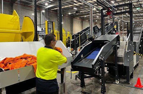 Once items are sorted based on composition or colour, they are fed through a conveyor belt that creates textile squares.