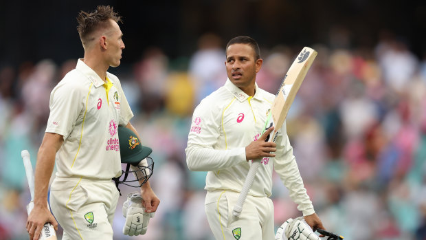 Australia’s Marnus Labuschagne and Usman Khawaja leave the field due to bad light on day one at the SCG.
