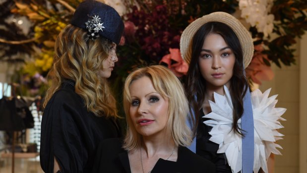 Milliner Nerida Winter (centre) with two models showing the trends for the season, which include oversized brims.