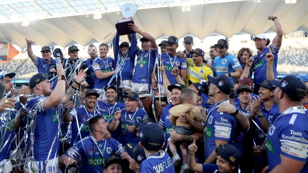 Newtown Jets celebrate their grand final win at Bankwest Stadium.