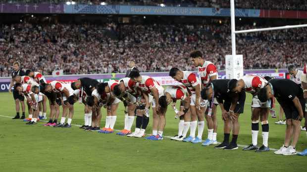 Take a bow: Japan players salute their fans.