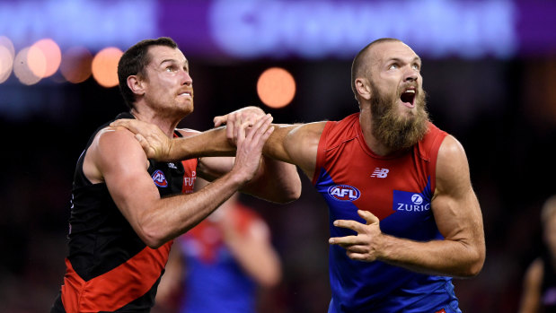 Leading the way: Melbourne ruckman Max Gawn gets in front spot against Essendon's Matthew Leuenberger.