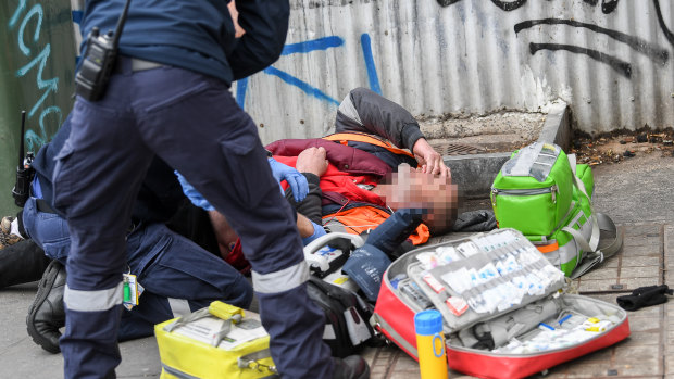 Paramedics attend to an overdose on Victoria Street in Richmond in 2019.