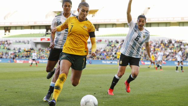 Hot pursuit: Steph Catley on the chase for possession out wide for Australia.