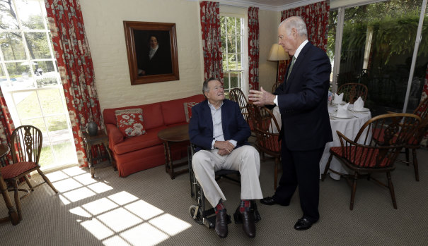 Former US president George H. W. Bush talks with his former secretary of state James Baker in 2012.