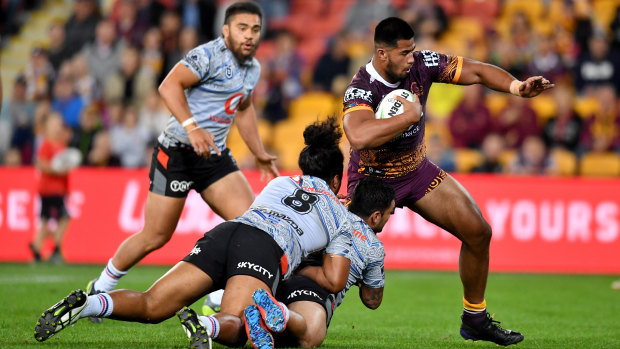 Payne Haas (right) of the Broncos gets past the Warriors defence to score a try in the round 17 draw at Suncorp Stadium.