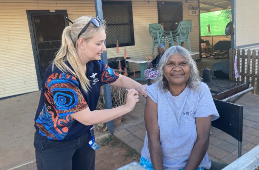 Cheryl Stewart receives her first dose of the Pfizer vaccine during a RFDS visit to the remote South Australian town of Oodnadatta.