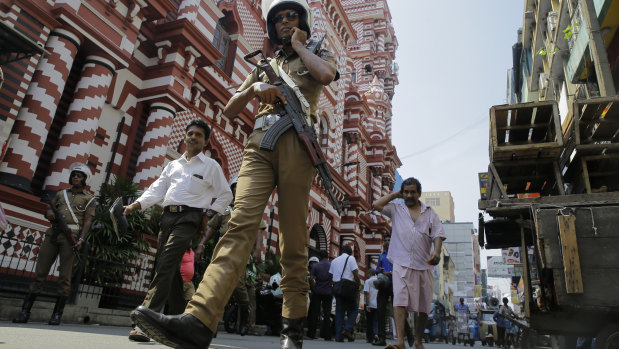 A Sri Lankan police officer patrols outside the same mosque last week in the wake of the Easter Sunday attacks.
