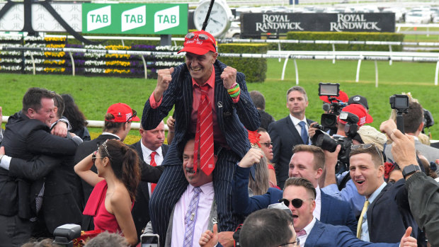 Connections of Redzel including Peter Piras (centre) celebrate their second Everest victory in 2018.